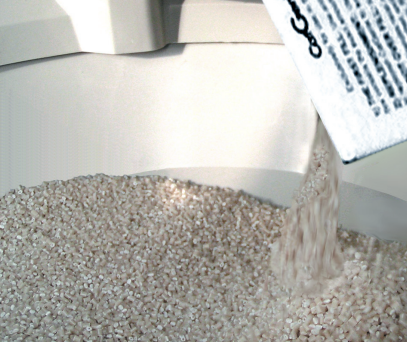 Filling Cat Genie A.I. litter box with washable granules