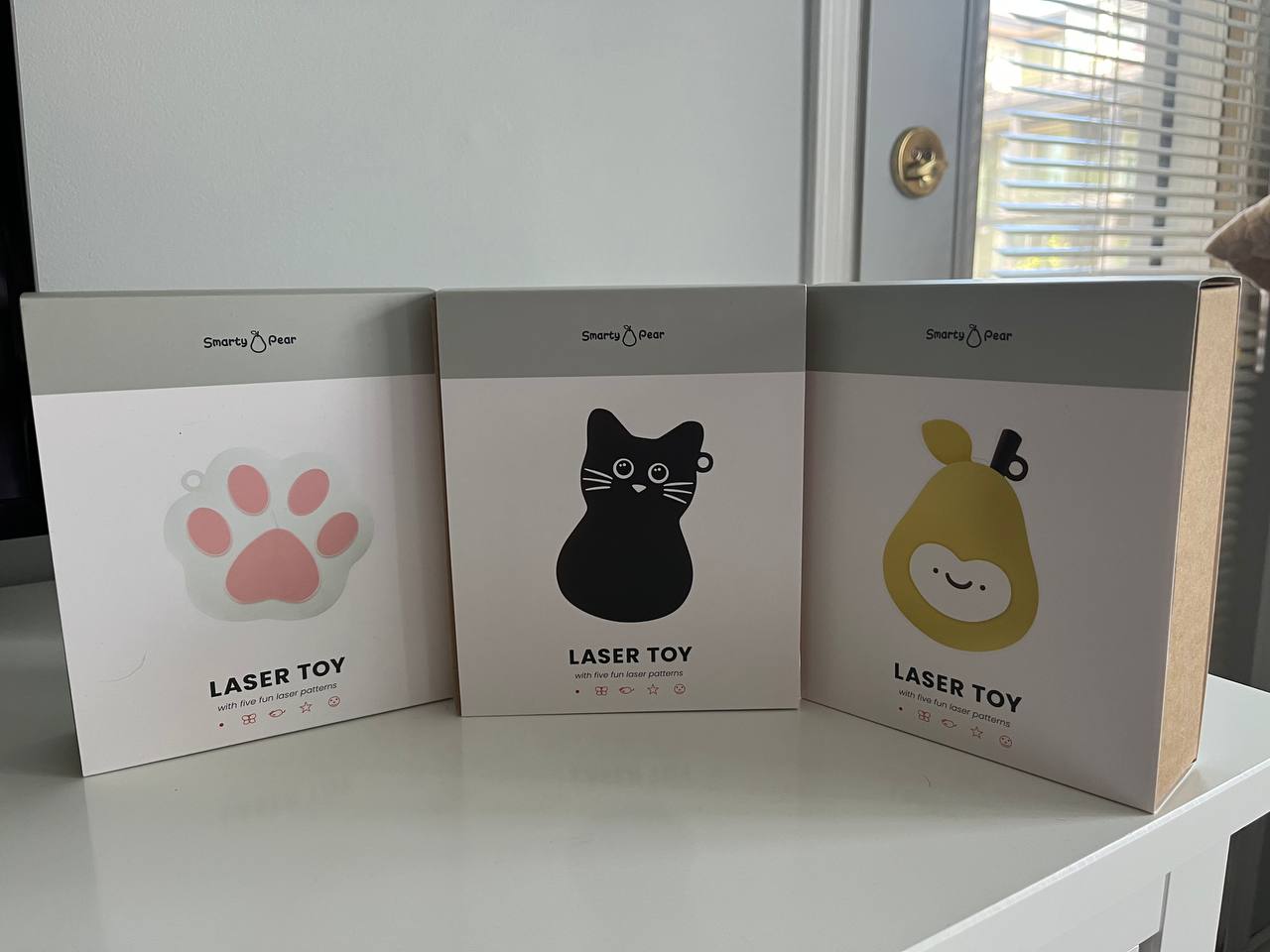 Different versions of Smarty Pear electronic laser toy for cats