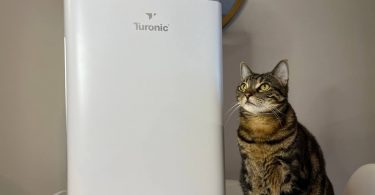 My cat is posing near Turonic PH950 Hepa Air Purifier